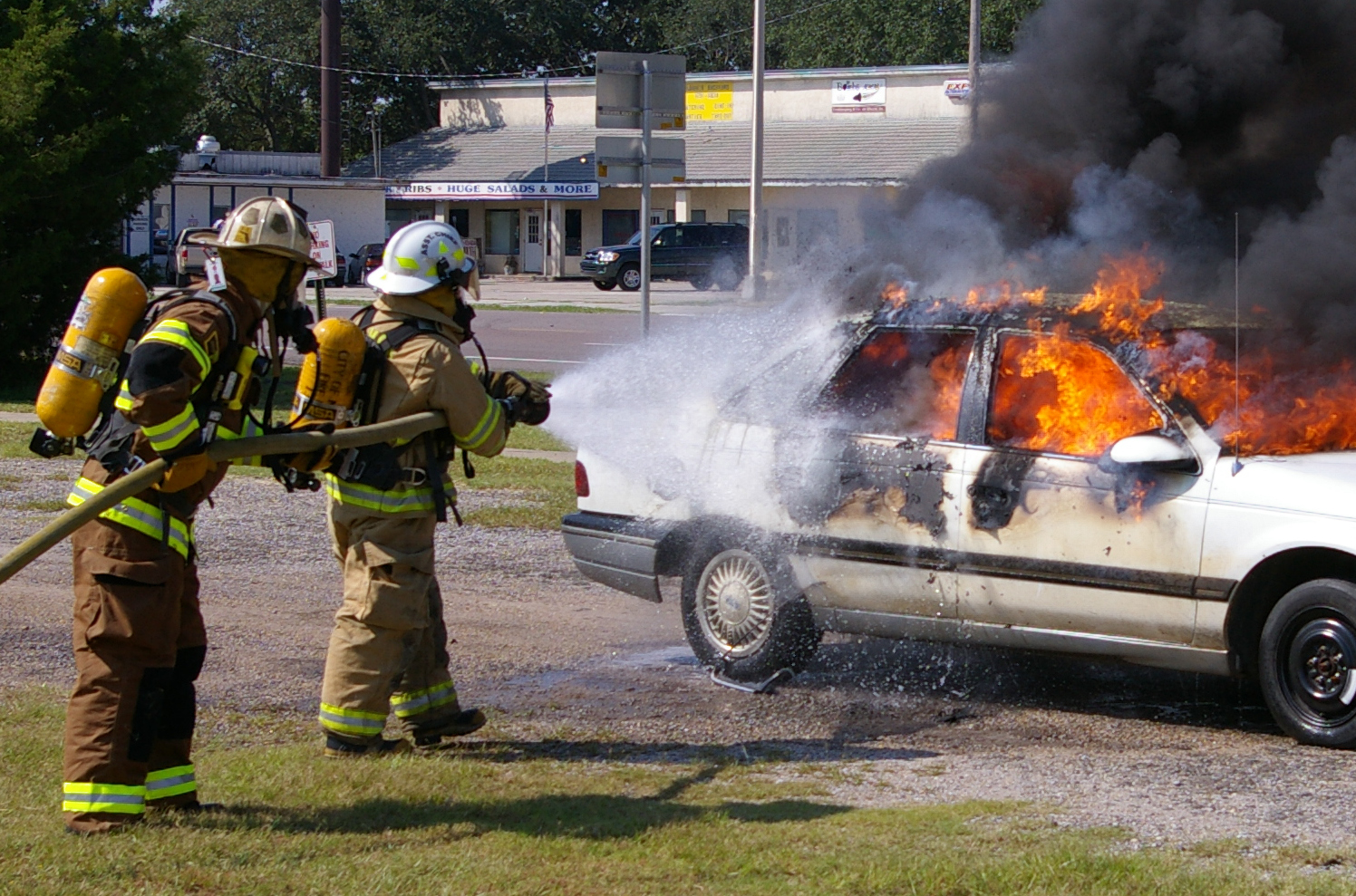 Students Extinguishing a Car Fire